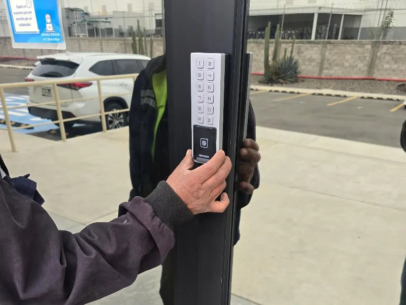 Lector Hikvision con teclado y huella instalado en la puerta de acceso de una empresa en Querétaro